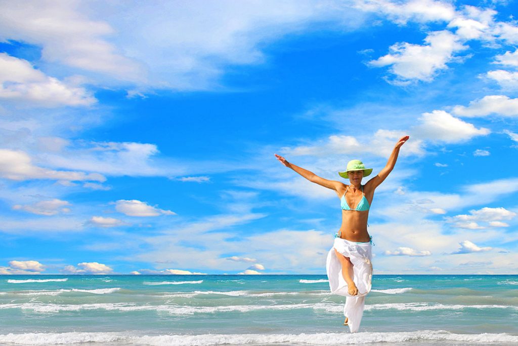 Lady jumping on beach