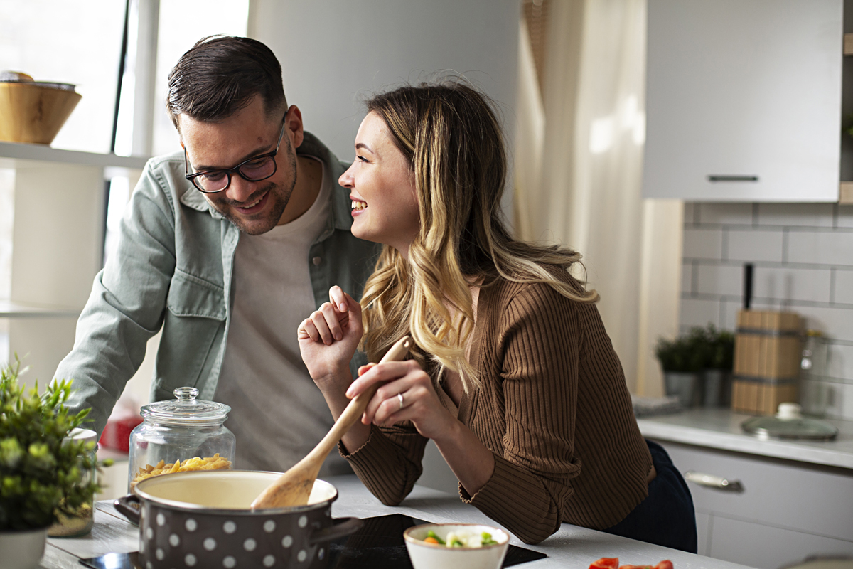 Young couple cooking at home