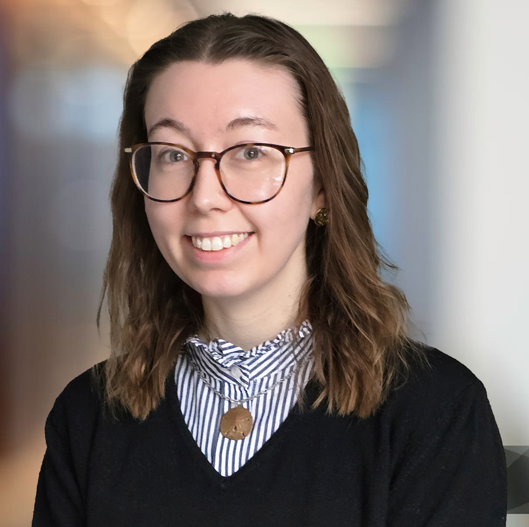 Modern office corridor with walls of glass defocused background. Katie Oldfield - Paraplanner and Case Completions Manager